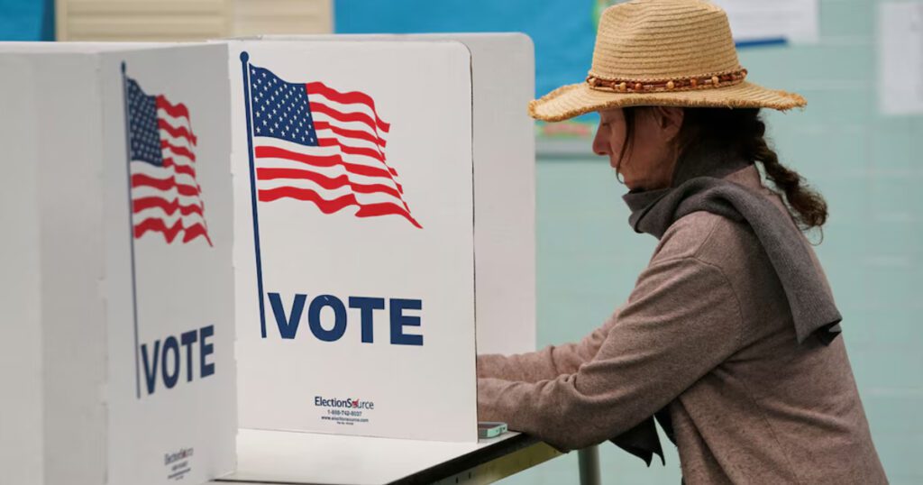 A voter casts her ballot at a polling station on Election Day in Falls Church, Virginia, U.S., November 7, 2023. REUTERS/Kevin Lamarque