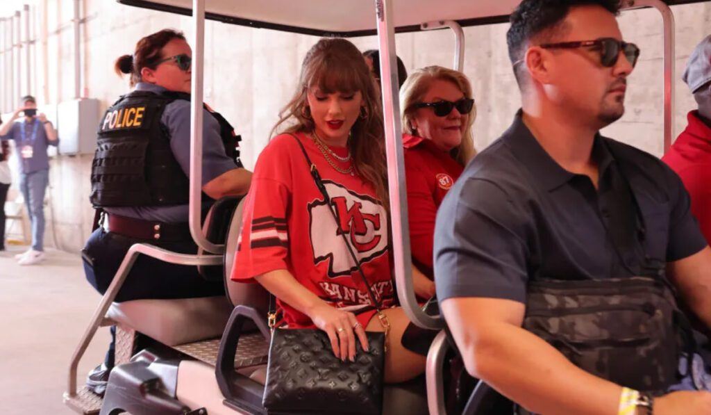 Taylor Swift at a football game between the "Cincinnati Bengals and Kansas City Chiefs" on Sept. 15 in Kansas City, Missouri, vintage t-shirt dress, Giuseppe Zanotti  long-boots